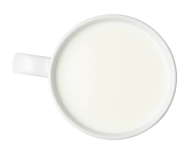 istock Cup full of milk isolated on white. Close quarters. 1157980066
