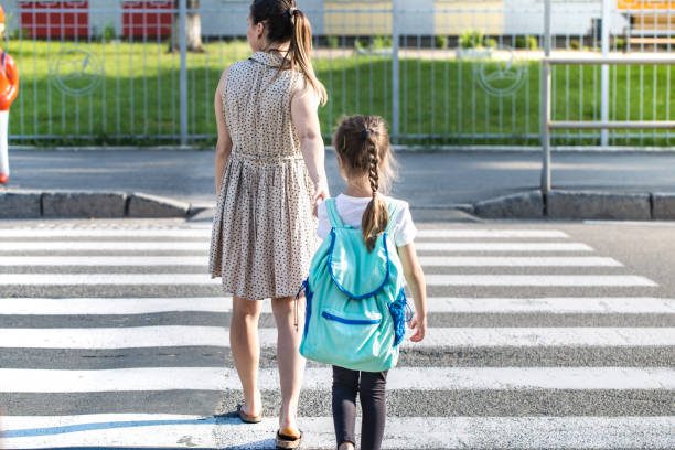 istock Back to school education concept with girl kids, elementary students, carrying backpacks going to class 1157981863