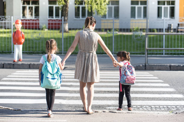 istock Back to school education concept with girl kids, elementary students, carrying backpacks going to class 1157981865