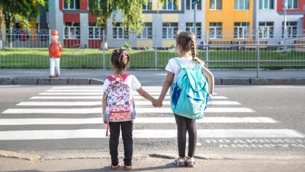istock Back to school education concept with girl kids, elementary students, carrying backpacks going to class 1157981873
