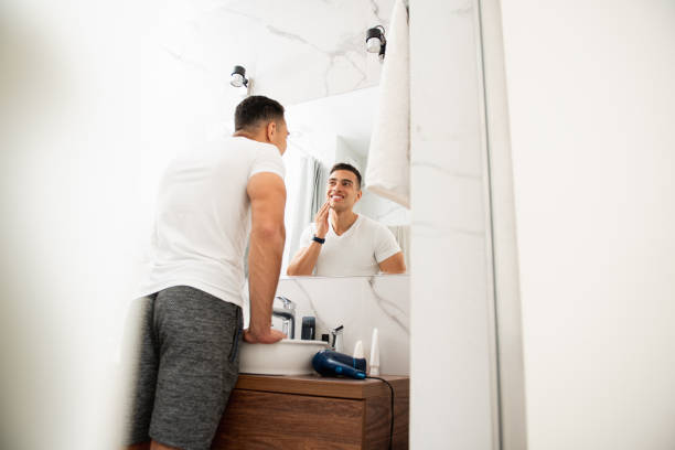 istock Happy satisfied man looking at his shaving face 1157982991