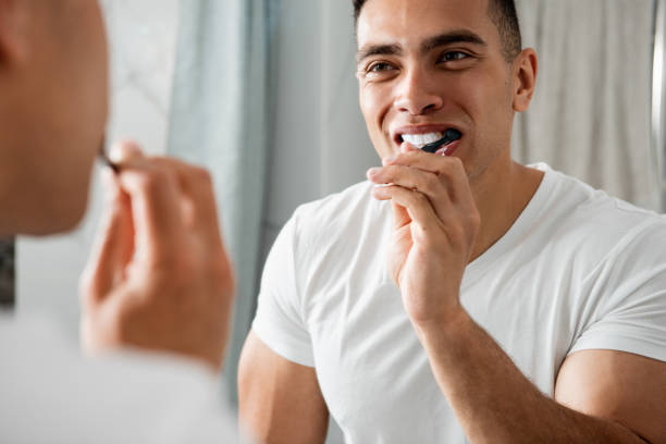istock Reflection of young smiling man brushing teeth 1157983025