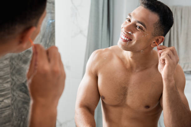 istock Young happy man cleaning ears by Q-tip 1157983144