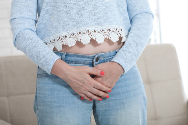 istock Woman Suffering From Bladder Problem. Woman touching her groin with hands 1157983173