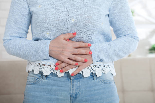istock Middle aged woman suffering from abdominal pain while at home 1157983175
