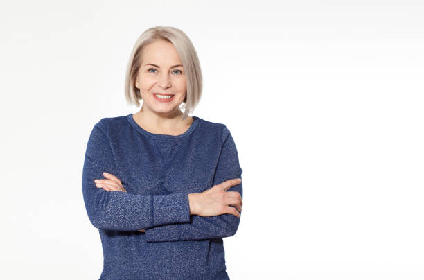 istock Attractive middle aged woman with folded arms on white background 1157983707