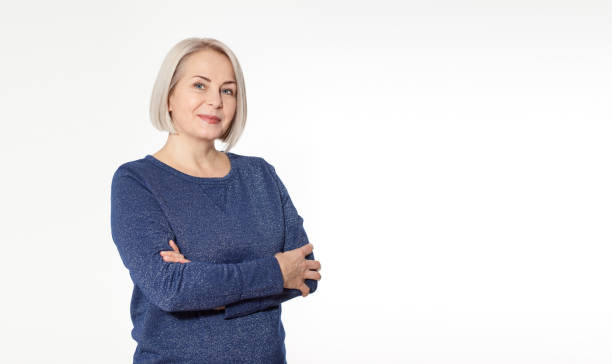 istock Attractive middle aged woman with folded arms on white background 1157983712