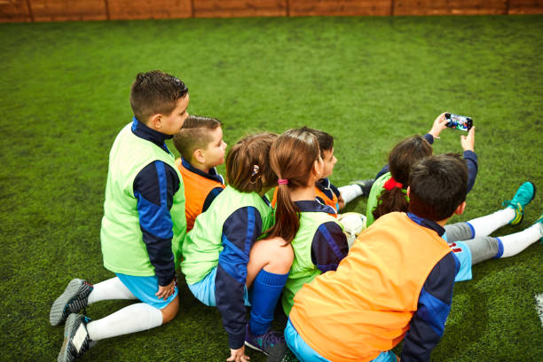 istock Group Of Kids Making Selfie After Soccer Training 1157984558