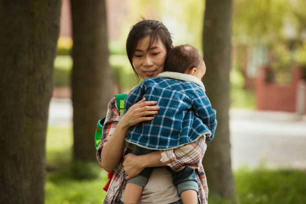 istock Son Sleeping in his Mother's arms 1157984694