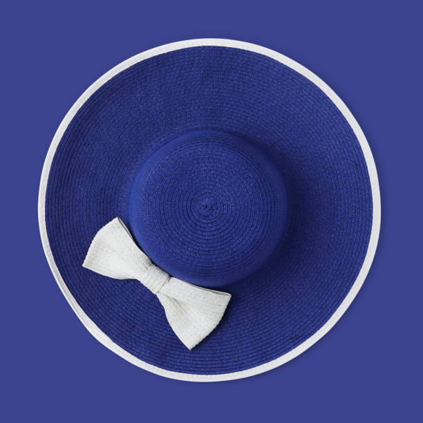 istock top view summer beach round straw blue hat with white bow isolated on blue background 1157984767
