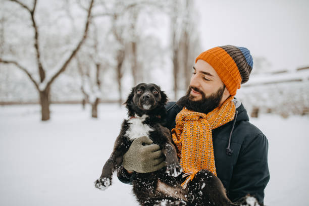 istock Man and his dog in snow 1157984962
