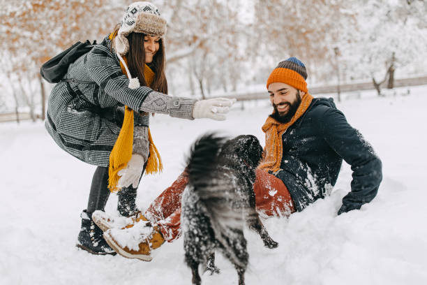 istock Happy young couple having fun in snow 1157985177