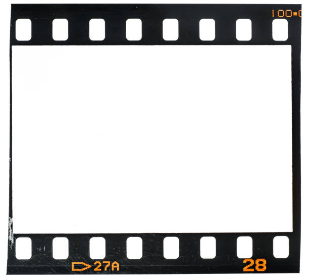Real and original 35mm or 135 film material or photo frame on white background, 35mm filmstrip with empty window or cell with dust and scratches real 35mm film material with empty cell or frame, macro photo, no scan 16mm film motion picture camera photos stock pictures, royalty-free photos & images