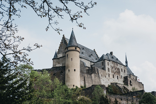 Vianden, Luxembourg - May 18, 2019: Low angle against the sky view of Vianden Castle, Luxembourg, one of the largest and finest feudal residences of the Roman and Gothic eras in Europe.