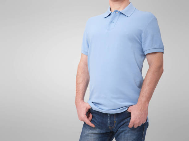 istock Man wearing blank blue t-shirt isolated on white background with copy space. Tshirt design and people concept - close up of men in blank shirt. For mock up template design. Front view 1157985757