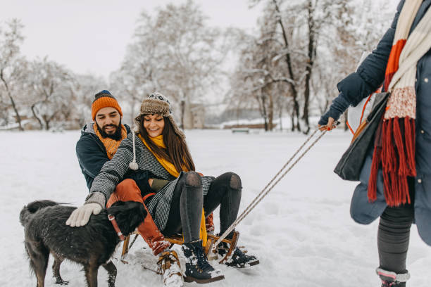 istock Happy young couple having fun in snow 1157985771