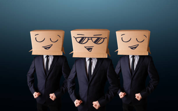 istock Handsome men in suit gesturing with drawn smiley faces on box 1157986386