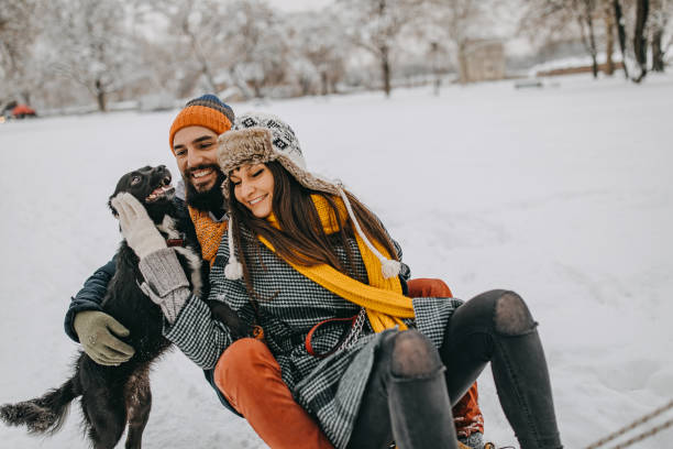 istock Happy young couple having fun in snow 1157986880