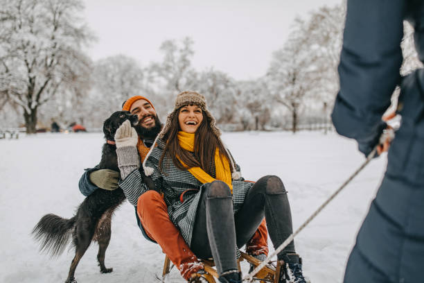 istock Happy young couple having fun in snow 1157987089