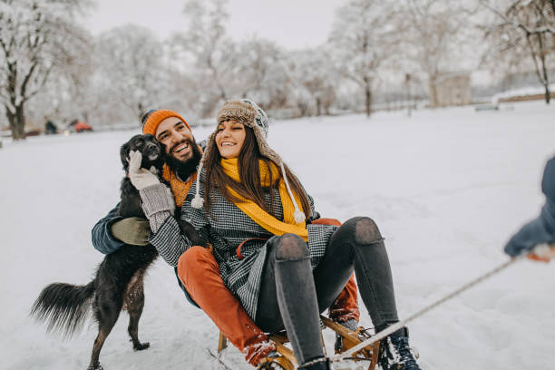 istock Happy young couple having fun in snow 1157987143