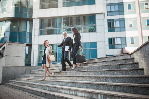 Business people walking down concrete steps