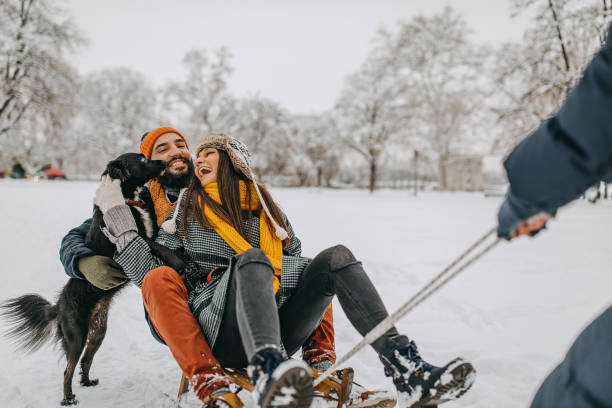 istock Happy young couple having fun in snow 1157987915