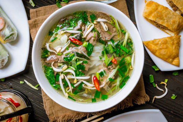 istock Assorted asian dinner, vietnamese food. Pho ga, pho bo, noodles, spring rolls 1157988147
