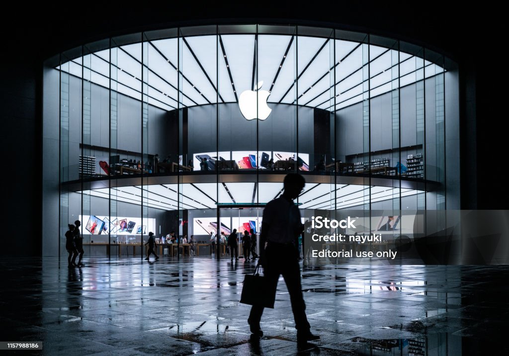 Apple stores in the evening, busy Apple stores and people on the road Nanjing, China - June 20, 2019: Apple stores in the evening, busy Apple stores and people on the road. Apple Computers Stock Photo