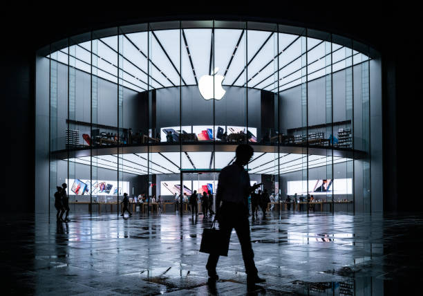 Apple stores in the evening, busy Apple stores and people on the road Nanjing, China - June 20, 2019: Apple stores in the evening, busy Apple stores and people on the road. apple computers photos stock pictures, royalty-free photos & images