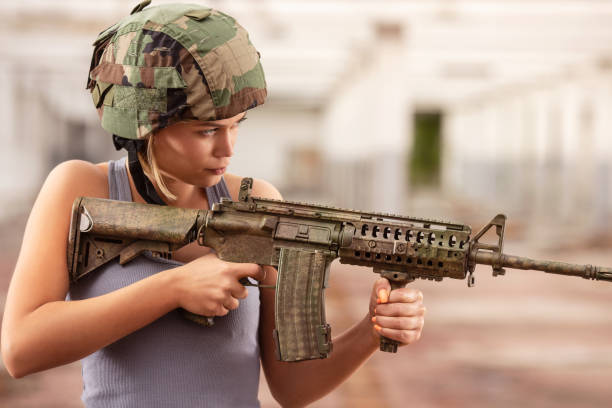 istock Young beautiful woman in airsoft game posing for a camera 1157988568