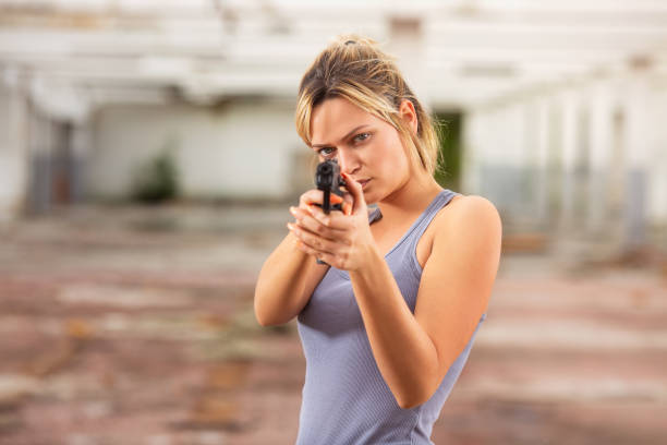 Young beautiful woman in airsoft game