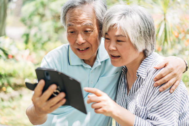 istock Beautiful senior couple using phone 1157989823