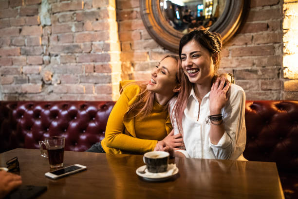 istock Two beautiful women having fun in a pub 1157990371
