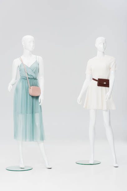 istock plastic mannequins with bags and dresses isolated on grey 1157991078