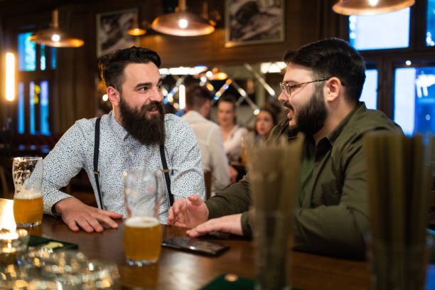 istock Hipster male friends drinking beer in a pub 1157991087