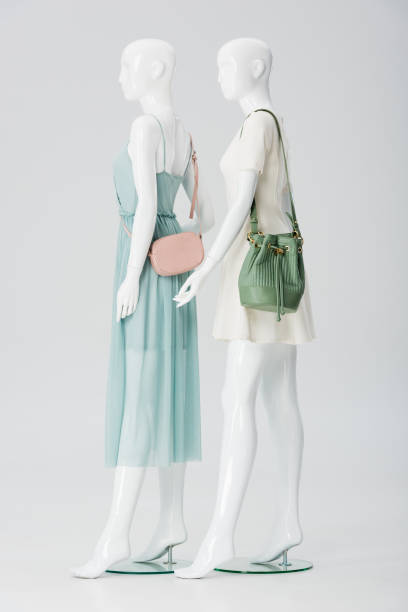 istock mannequins with bags and dresses isolated on grey 1157991110