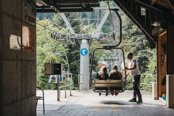 People getting on a chair lift in Vianden, Luxembourg. Vianden, Luxembourg - May 18, 2019: People getting on a chair lift in Vianden, a town in Luxembourgs Ardennes region known for the centuries-old hilltop Vianden Castle. vianden stock pictures, royalty-free photos & images