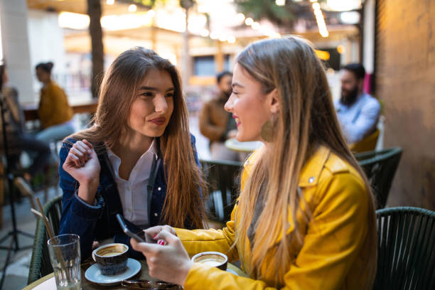 istock Beautiful women surfing the net in sidewalk cafe 1157992152