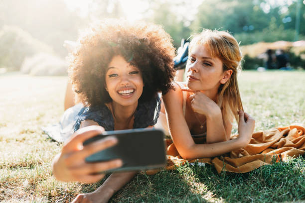 istock Two friends taking a selfie together at the park 1157992489