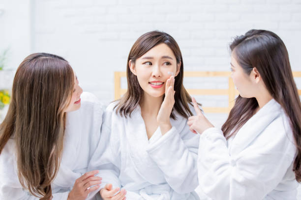 istock woman apply cream on face 1157992660