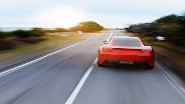 istock red car driving on a mountain road 1157993239