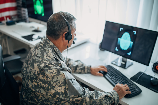 Army soldier using computer for identification blue digital fingerprint