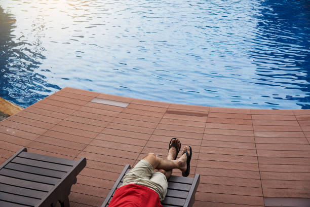 istock A man sitting near the swinmming pool 1157994885
