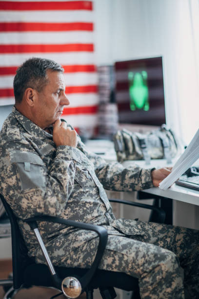 istock Army soldier working ona clasified document 1157995416