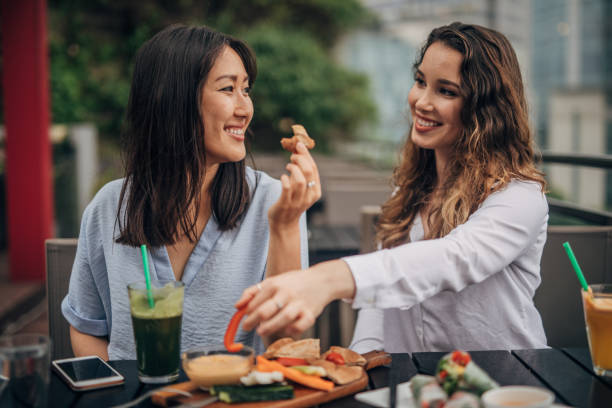 istock Two cheerful women having fun in a cafe 1157995917