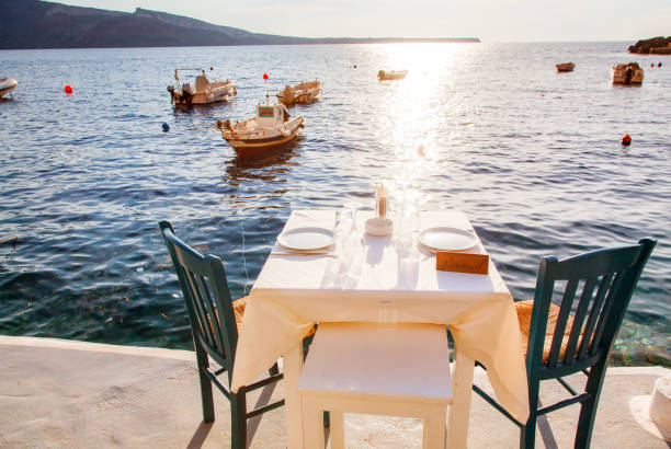 istock romantic dinner table by the sea Santorini, Greece 1157997259