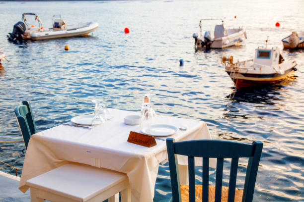 istock romantic dinner table by the sea Santorini, Greece 1157997282