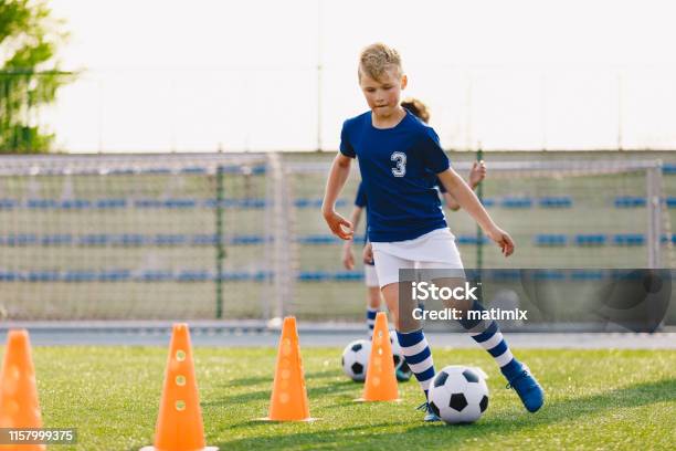 Soccer Camp For Kids Boys Practice Dribbling In A Field Players Develop Good Soccer Dribbling Skills Children Training With Balls And Cones Soccer Slalom Drills To Improve Football Dribbling Pace Stock Photo - Download Image Now