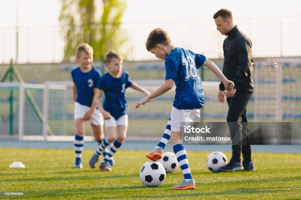 Football Training Practice Exercises for Youth Soccer Players. Boys on Training with Soccer Balls on Pitch Boys Stock Photo