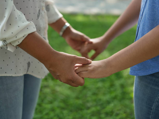 istock A mother's hand holding her daughters hands 1158001043